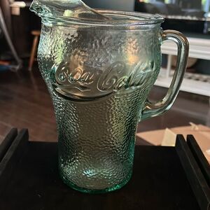 Vintage Coca-Cola‎ green glass pitcher. Measures 9” Tall.